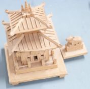 A collection of carved Eastern treen including handles, two buildings and a boat with figures