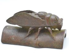 Japanese bronze depicting an insect on bamboo, to underside scorpion and snail, 6.5 x 3.5cm