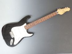 Encore electric rhythm guitar in black lacquered finish with contrasting white finger plate,