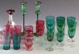 Twenty-five cranberry and green glasses and vases some with cut and flash overlaid decoration,