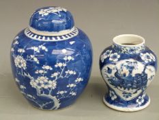 A 19thC Chinese covered ginger jar with prunus blossom decoration and one other, tallest 20.5cm