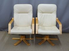 Two faux leather swivel armchairs