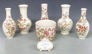 Five Zsolnay Pecs vases, jardiniere and an advertising plaque, tallest 26cm