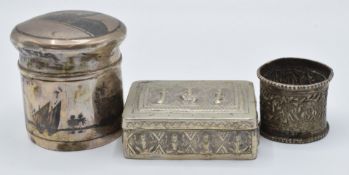Indian or Burmese white metal napkin ring with embossed decoration of animals and palm trees,