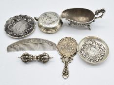 Chinese white metal comb, Chinese mirror, a phurba, sauce boat, two dishes, and a tea pot