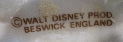 A set of seven Beswick Walt Disney Winnie The Pooh figures and two later Royal Doulton examples