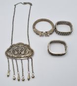 Three Chinese bangles and a Chinese white metal item