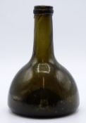 A 17th/18thC mallet shaped green glass wine bottle, 18cm tall.