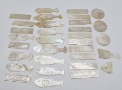 Eleven Chinese mother of pearl counters in the form of fish, fourteen rectangular mother of pearl