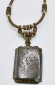 A nephrite jade pendant decorated with character marks and floral scene to verso
