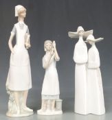 Three Lladro figures including nurses and nuns, tallest 41cm