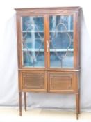 Edwardian astragal glazed mahogany display cabinet with cupboard under, raised on squared tapering