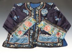 A 19thC Chinese coat with embroidered decoration and embossed brass buttons.