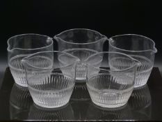 A set of five cut clear glass wine rinsing bowls with double spouts, each approximately 14cm in
