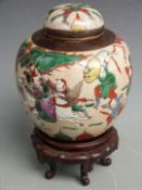 A 19th/20thC Chinese crackle glazed covered ginger jar decorated with a battle scene and impressed