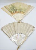 An early 20thC carved mother of pearl fan in original Selfridges, London box and a bone fan