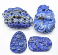 Two Chinese lapis lazuli carvings depicting Foo Dogs and two Chinese lapis lazuli pendants depicting