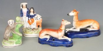 Four Staffordshire figures including two greyhound pen stands, monkey etc, tallest 16cm