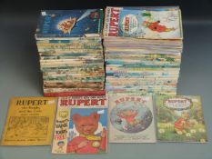 Ninety-six Rupert related books, annuals and comics including annuals from 1938 onward, Rupert