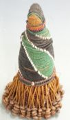 A late 19th/20thC Africian tribal beadwork figure with trailing pierced seed/treen skirt, H20cm