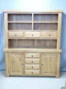 Modern oak dresser with shelves and thee drawers to top and four drawers flanked by cupboards to