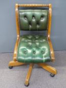 Green Chesterfield style desk or office chair raised on castors