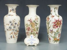 Three large Zsolnay Pecs vases and an advertising plaque, tallest 34cm