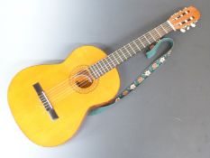 Almeria Spanish folk acoustic guitar fitted with six nylon strings, with embroidered shoulder strap,