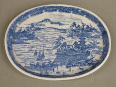 A 19thC Chinese oval shallow dish decorated with ships and buildings and impressed seal mark to