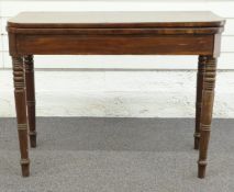 19thC cross banded mahogany fold over games table raised on turned tapering legs, H69 x W91 x D45cm