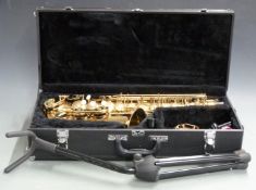 Earlham Alto saxophone with accessories and stand, in hard fitted case