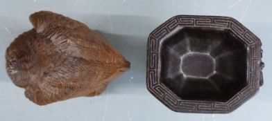 A carved wooden eagle and a libation cup with impressed mark to base, tallest 19cm