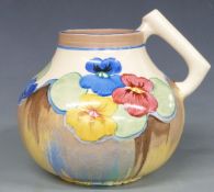 Clarice Cliff for Newport Pottery Bizarre jug decorated in the Pansies pattern, shape no. 634,