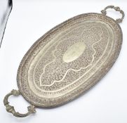 Indian or Burmese white metal two handled tray with embossed decoration, given to the vendor's