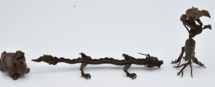 Three Japanese bronzes, a dragon, plant and creature, 15.5 x 4cm