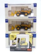 Four diecast model commercial vehicles, three Komatsu comprising two WA600 and PC450LCD, and Norscot