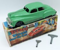 Tri-ang Wizard Stop-On clockwork model car with green body, black wheels, two keys, silver bumpers
