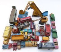 Over 50 Dinky Toys diecast model vehicles and accessories including Lyons Swiss Rolls Guy Lorry,