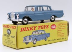 Dinky Toys Mercedes Benz 220 SE diecast model with blue body, white interior and silver hubs, 186,