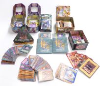 A collection of Pokemon and Yu-Gi-Oh trading cards, some in matching tins and boxes.