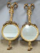 A pair of gilt framed mirrors with swag decoration, W24 x H65cm