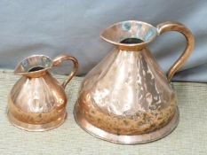 Two Victorian copper measuring jugs with VR ciphers ' 1/2 Gallon' and '2 Gallon', tallest 33cm