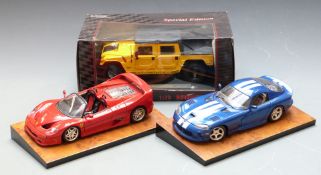 Three 1:18 scale diecast model vehicles comprising Maisto Special Edition Hummer Soft Top, Ferrari