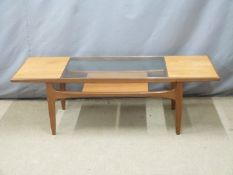 A retro / mid century modern glazed coffee table with undershelf, W136 x D51 x H43cm