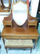 Edwardian inlaid mahogany dressing table with bevelled glass shield shaped swing mirror, raised on