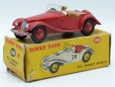 Dinky Toys diecast model M.G. Midget Sports with red body and hubs, beige driver and brown
