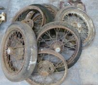 Six Austin Seven wheels comprising an early 6 inch braked example, three examples with Austin script