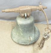 A large 19thC bronze bell attached to a cast metal suspension bar with rope pull attachment. We