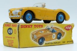 Dinky Toys diecast model Austin-Healy 100 Sport, with yellow body, beige driver, blue interior and