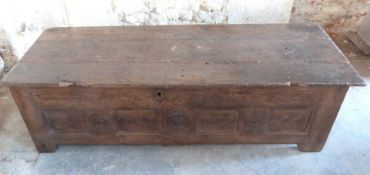 A 17thC carved elm coffer with three plank top, W173 x D60 x H55cm